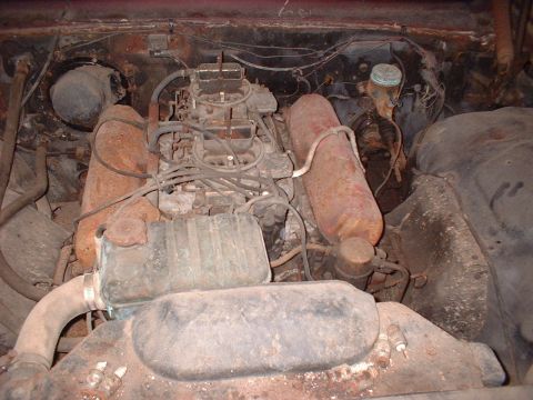 1963 Ford Galaxie - Close-up view of a V8 engine bay, showing dual carburetors and aged parts.