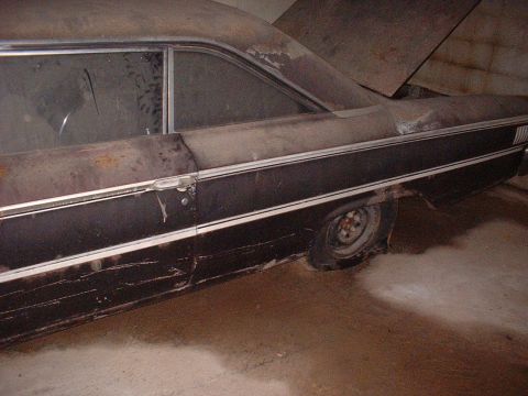 1963 Ford Galaxie - This 1963 Ford Galaxie sedan shows significant rust and wear, with its hood propped open.