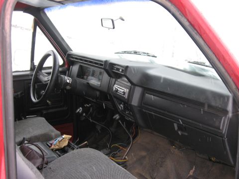1981 Ford Bronco - Interior of a red truck, likely from the early 1980s, showing the dashboard and seating area.