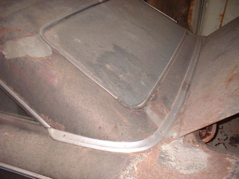 1963 Ford Galaxie - This photo shows the weathered roof and window frame of a car, with a wheel visible in the background.