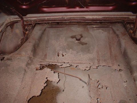 1963 Ford Galaxie - The trunk floor shows significant rust and damage, indicating a need for restoration.