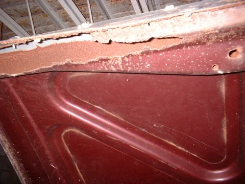 1963 Ford Galaxie - Corrosion and rust are visible on the edge of a car's hood.