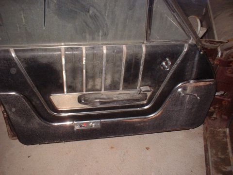 1963 Ford Galaxie - Close-up of a vintage car's interior door panel, showing the design of the handle and trim.