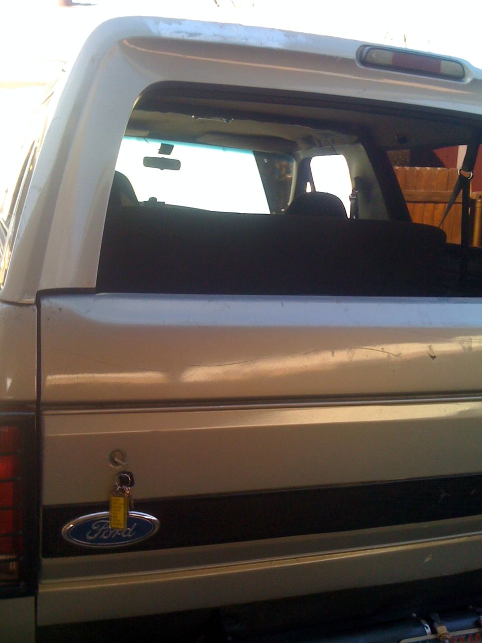 Rear view of a 1992 Ford Bronco with a Ford badge and a key in the lock