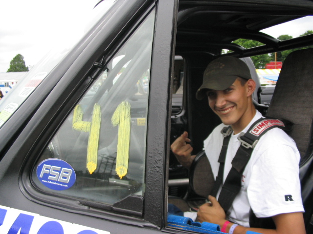 Guy in a race car with number 41 on the window and a Simpson racing harness