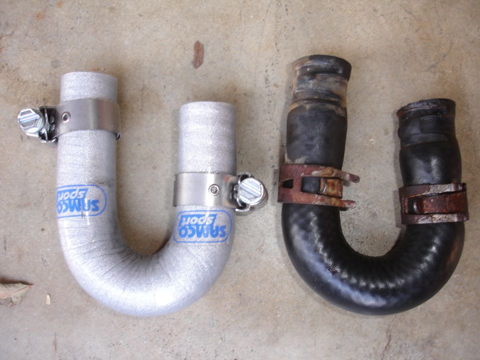 New silver Samco Sport radiator hose next to old black rubber radiator hose with rusty clamps