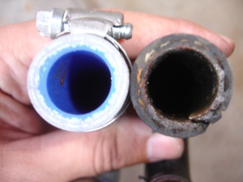 1992 Ford Taurus - A new blue hose is shown next to a deteriorated old hose, highlighting the difference in condition.