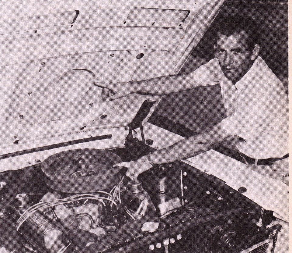 Man points to air cleaner and hood insulation in a 1968 Ford Mustang engine bay