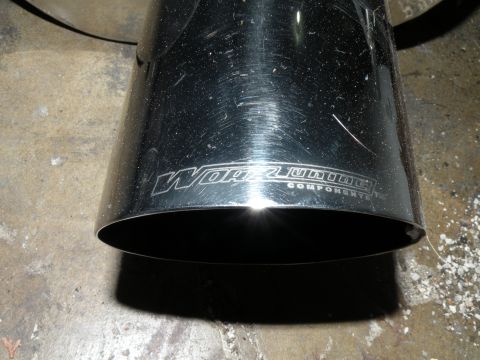 1998 Subaru Legacy - A close-up view of a chrome exhaust tip with a brand logo etched into it.
