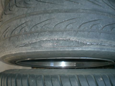 1997 Mercury Cougar - Tire sidewall damage is visible, showing exposed cords and potential failure.