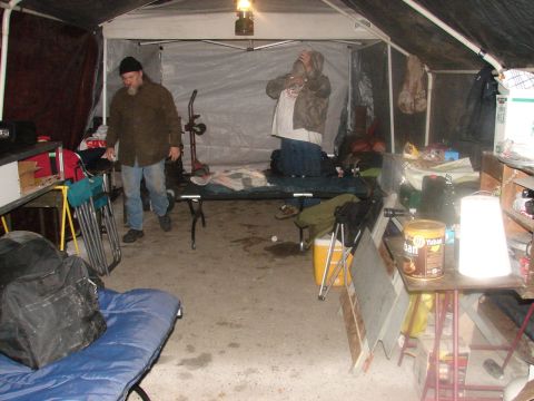 1973 Ford Ranchero - The interior of a temporary shelter is set up with sleeping arrangements and various supplies.