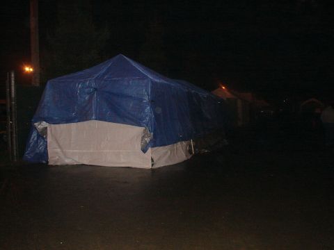 1973 Ford Ranchero - Tents are illuminated by distant lights in the darkness.