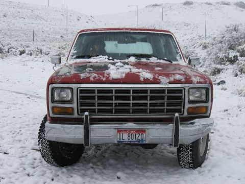 1981 Ford Bronco - Red Ford Bronco in snowy conditions, front view. License plate IL 80120 is visible.