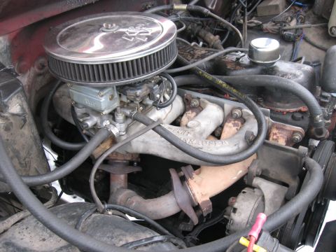 1981 Ford Bronco - Close-up of a V8 engine bay showing a chrome-topped K&N air filter mounted on a Holley carburetor over an aluminum intake manifold, with ex…