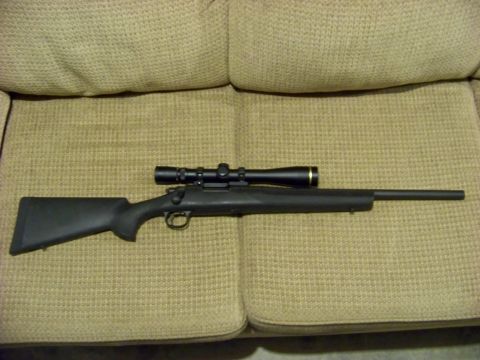 1995 Mercury Grand Marquis - Rifle with scope on fabric surface.