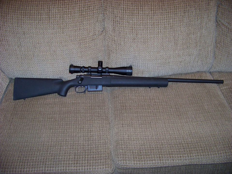 Rifle with scope on couch cushions