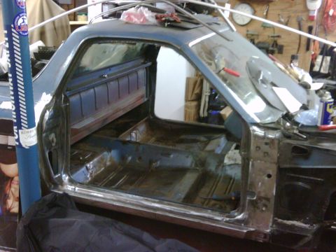 1971 Ford Ranchero - The interior of a blue 1971 Ford Ranchero is shown during restoration, with the floor pan and door frame visible.