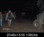 1979 Ford Bronco - Several people gather around an off-road vehicle in a dark, outdoor setting.
