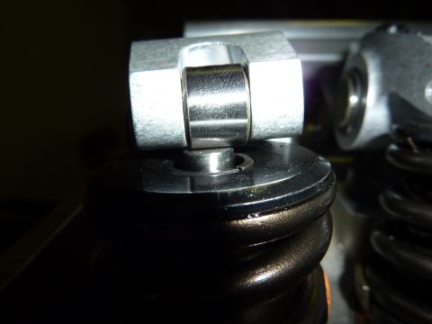 1971 Ford Mustang - This is a close-up view of a roller rocker arm assembly, part of an engine's valve train.