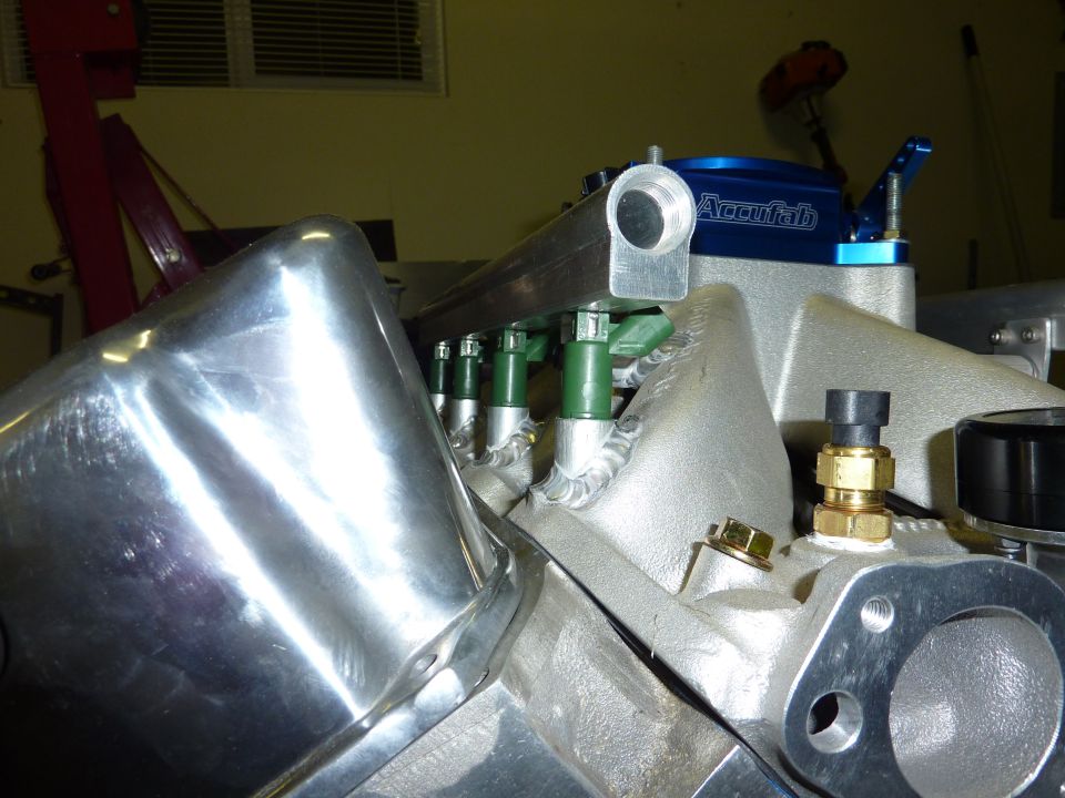 Aluminum EFI intake manifold with blue Accufab throttle body and green fuel injectors