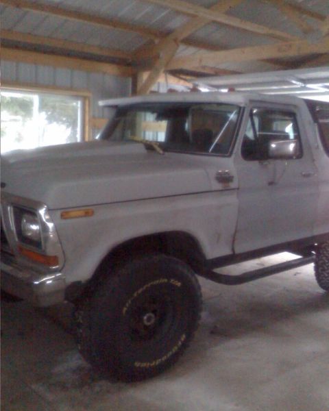 1979 Ford Bronco - This Ford Bronco is parked indoors, showing its large off-road tires and custom side steps.