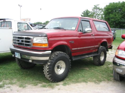 1986 Ford Bronco - This red 1986 Ford Bronco, seen at the Essex Junction Truck Show, features a lifted suspension and oversized tires.