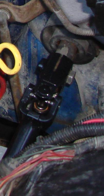 1984 Ford Bronco - This image shows a close-up of a vehicle's steering shaft universal joint and associated wiring.