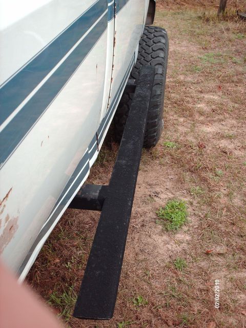 1982 Ford F-100 - Side view of a 1982 Ford F-100 pickup truck with a running board and off-road tire.