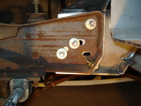1991 Ford Bronco - Close-up of a heavily rusted metal bracket with visible bolts and hardware.