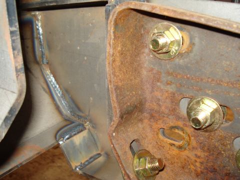 1991 Ford Bronco - Welded metal frame section with rusty bracket and bolts, likely part of a vehicle chassis.