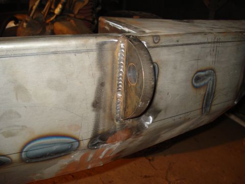 1991 Ford Bronco - This image shows a close-up of a fabricated metal component with visible welds and markings.