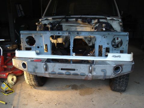 1991 Ford Bronco - Front view of a 1991 Ford Bronco undergoing modifications, showing the engine bay and custom bumper.