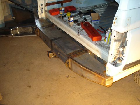 1991 Ford Bronco - Custom rear bumper fabrication in progress, with tools and parts laid out.