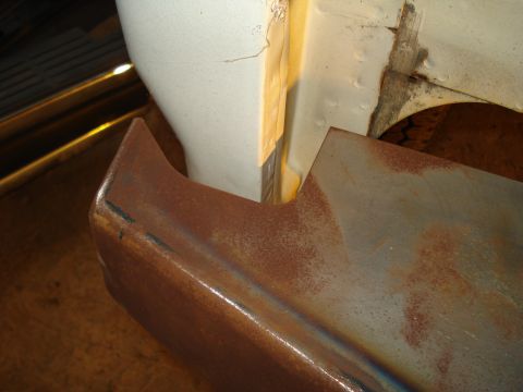 1991 Ford Bronco - Close-up of a rusted metal part with sharp edges, adjacent to a white painted surface.