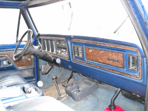 1993 Ford F-150 - The interior of a blue Ford Ranger XLT truck, wood grain trim on the dashboard and door panels.