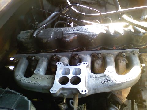1981 Ford Bronco - Close-up of an Offenhauser 'Dual-Port' aluminum intake manifold installed on an inline-six engine, with a 4-barrel carburetor adapter/space…