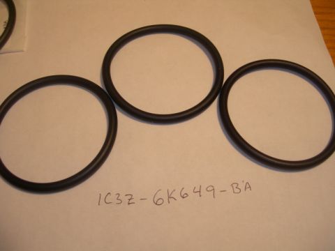 1984 Ford Bronco - A close-up view of three rubber o-rings, with part number identification written on the surface.