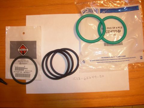 1984 Ford Bronco - Several o-rings are laid out on a table, some in packaging with part numbers and manufacturer logos.