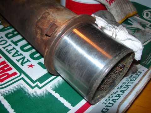 1984 Ford Bronco - A close-up of a rusty exhaust pipe section, showing wear and tear.