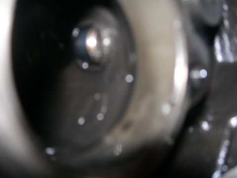 1984 Ford Bronco - A close-up view of a mechanical part, possibly from an engine, with visible reflections.