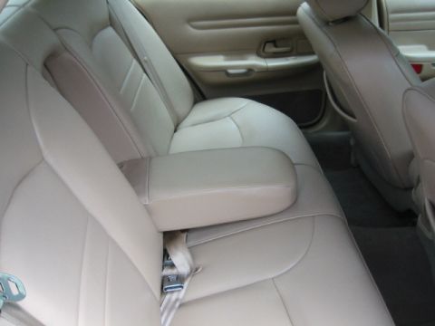 1998 Ford Crown Victoria - The interior of a 1998 Ford Crown Victoria shows beige leather seats and door panels.