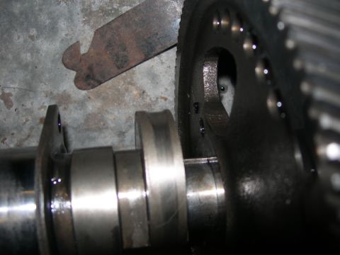 1984 Ford Bronco - Close-up of a camshaft and gear assembly, with a tool positioned nearby.