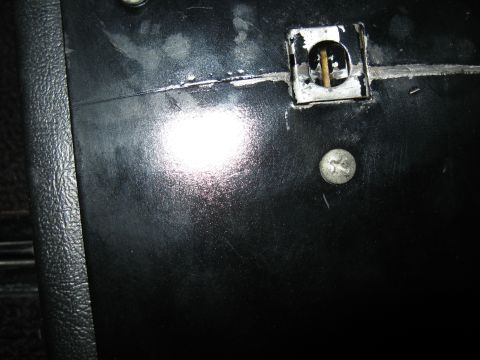 1968 Shelby GT500 - Close-up of a black interior door panel, showing a screw and a metal latch mechanism.