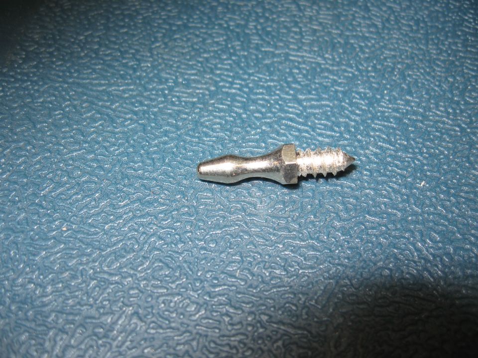 Plated hex-collar striker pin with tapered nose and coarse threads on a blue mat