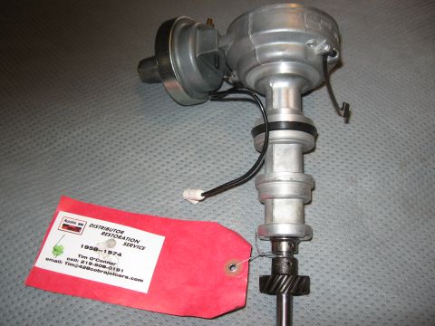 1968 Shelby GT500 - A metal distributor with a red tag attached, listing contact information for Distributor Restoration Service.