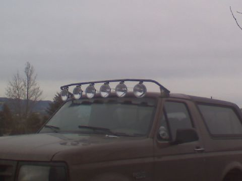 1993 Ford Bronco - A brown 1993 Ford Bronco is shown with a light bar installed on its roof.
