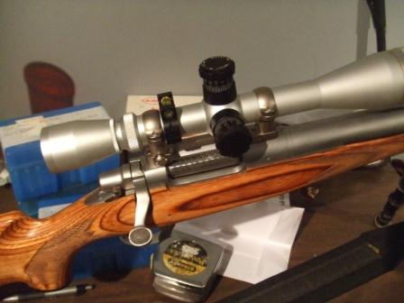 1996 Ford Bronco - A rifle with a scope is shown on a table, with a small level bubble attached to the scope mount.