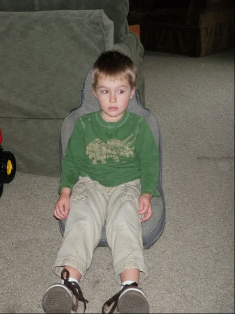1994 Ford Bronco - A young boy sits on a guitar case indoors, with a couch in the background.