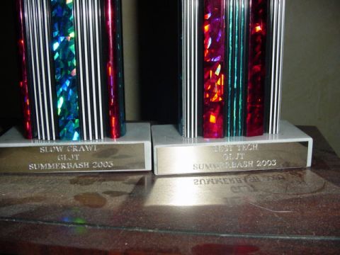 1992 Ford Bronco - Two trophies awarded at Summerbash 2003 are displayed on a table.