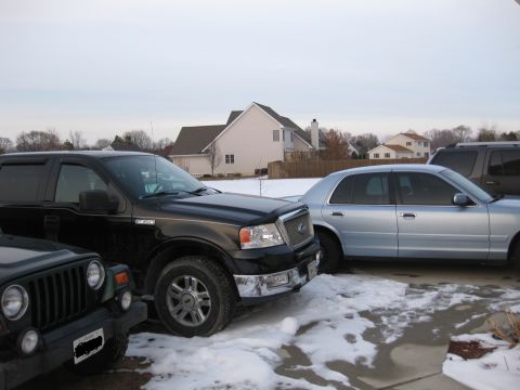 1999 Ford Crown Victoria - My sister's 2000 jeep wrangler and my brother's 2004 lariat F-150 fully loaded and a 2006 explorer on the other side